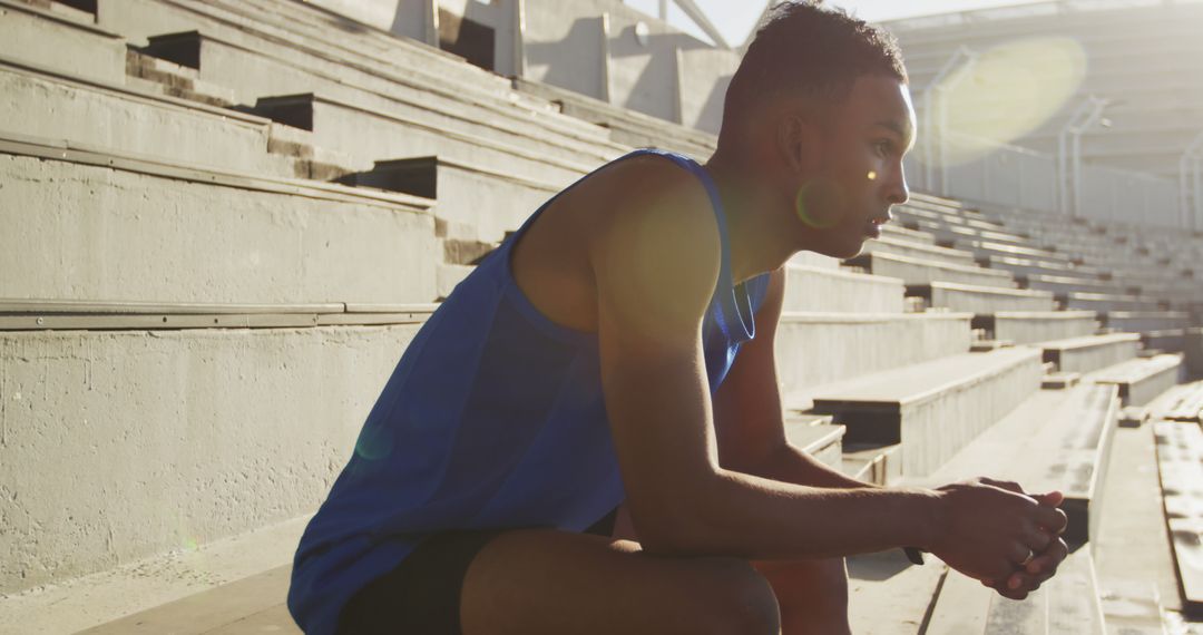 Young Athlete Relaxing on Empty Stadium Stands - Free Images, Stock Photos and Pictures on Pikwizard.com