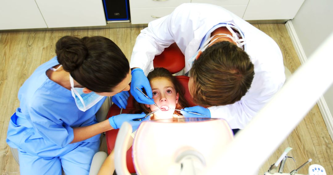 Child at Dental Clinic with Dentist and Dental Assistant - Free Images, Stock Photos and Pictures on Pikwizard.com