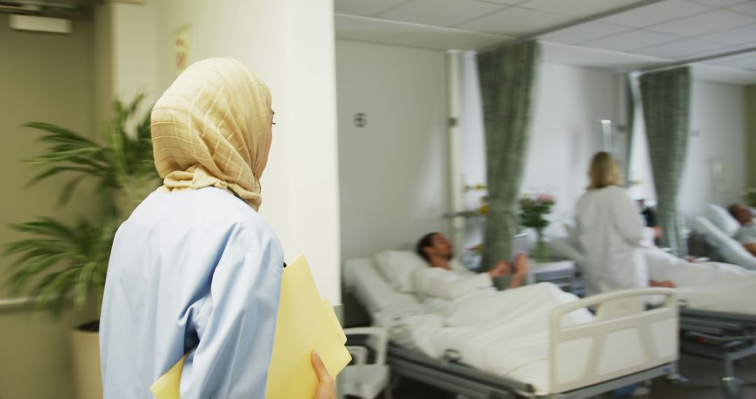 Muslim Nurse Walking Through Hospital Ward - Free Images, Stock Photos and Pictures on Pikwizard.com