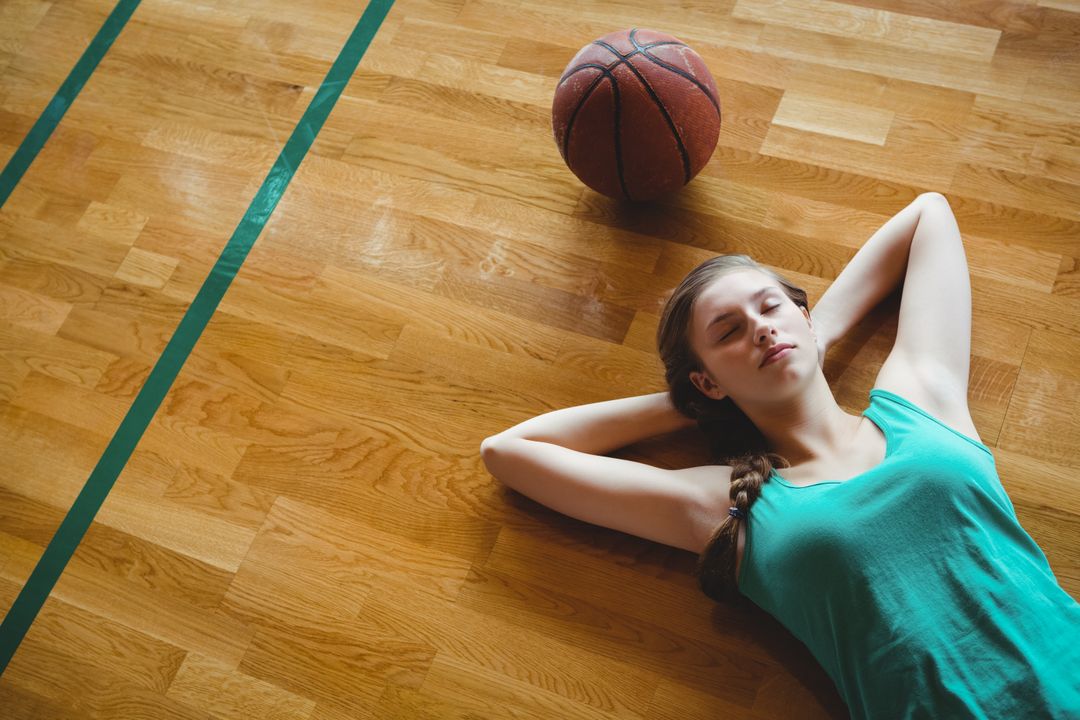Female Basketball Player Resting on Court - Free Images, Stock Photos and Pictures on Pikwizard.com