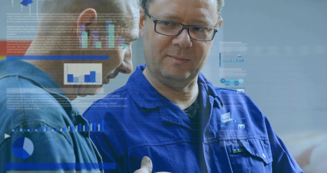 Technician collaborating and reviewing digital diagnostics charts in industrial workshop