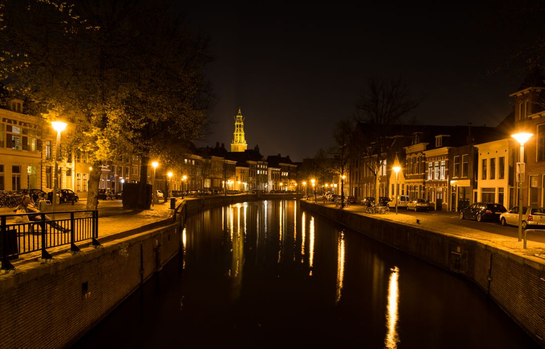 Scenic Night View of Picturesque Canal and Illuminated Tower - Free Images, Stock Photos and Pictures on Pikwizard.com