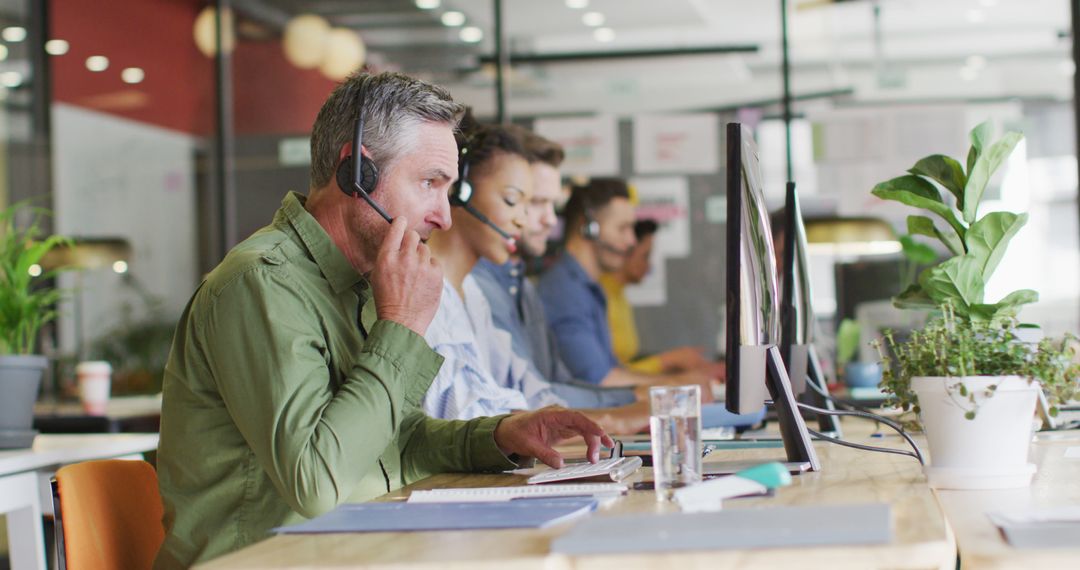 Diverse Customer Service Reps Using Headsets in Modern Office - Free Images, Stock Photos and Pictures on Pikwizard.com