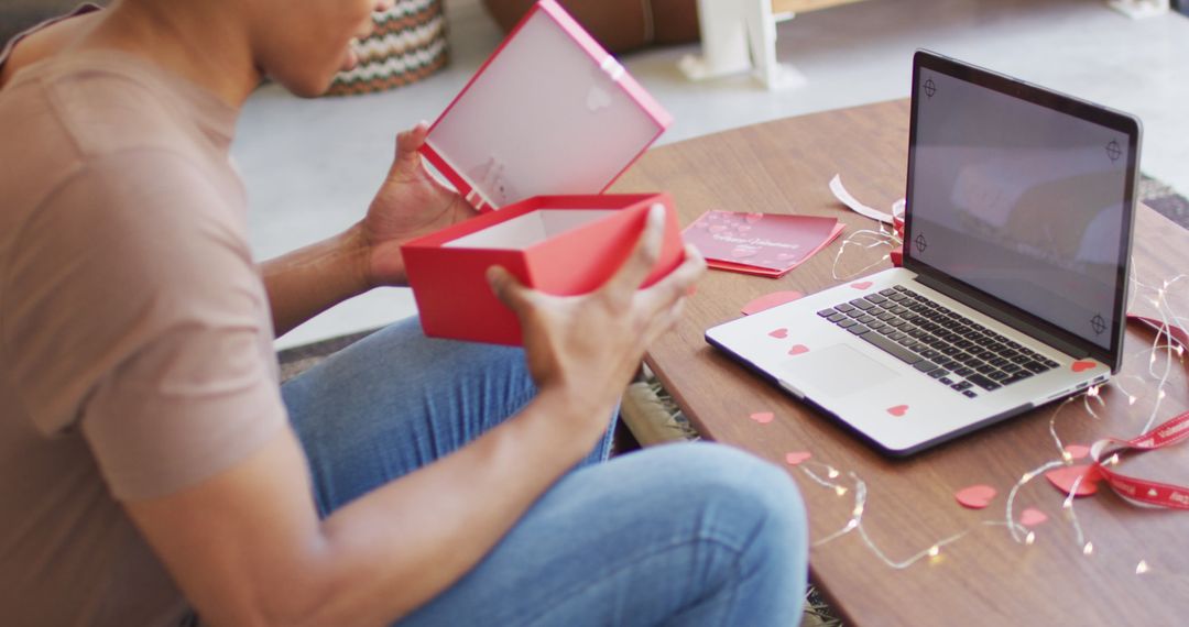 Smiling Man Video Calling with Laptop Opening Gift Box