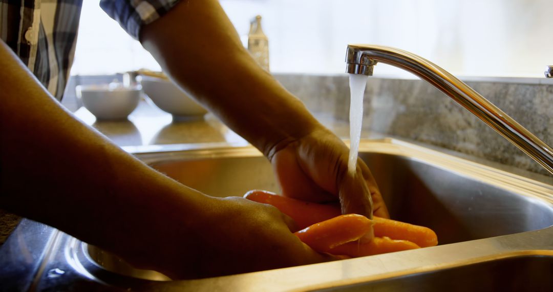 Person Washing Carrots in Kitchen Sink - Free Images, Stock Photos and Pictures on Pikwizard.com