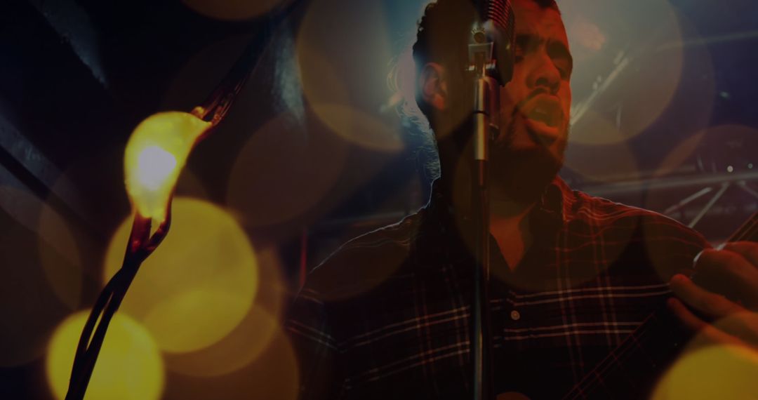 Musician Passionately Performing on Stage with Dynamic Lights