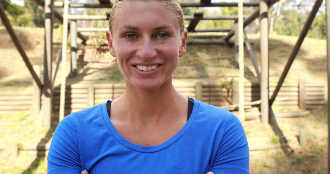 Confident woman in blue top promoting fitness outdoors