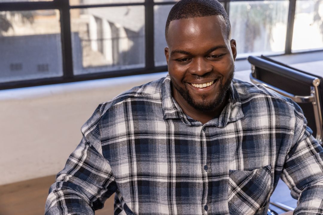 Smiling Professional Sitting in Modern Office