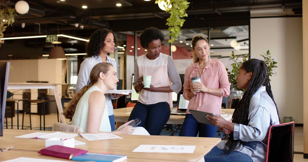 Diverse Women Collaborating in Modern Workspace