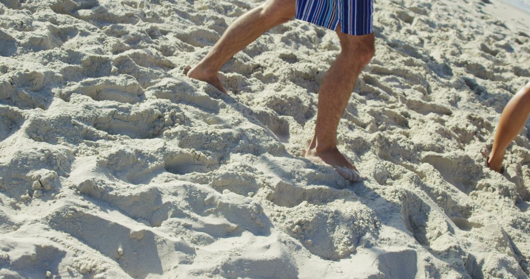 Man Walking on Sandy Beach in Summer - Free Images, Stock Photos and Pictures on Pikwizard.com