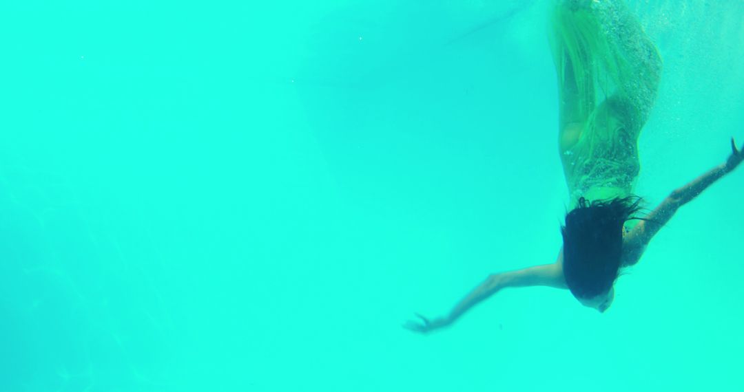 Woman Swimming Underwater Gracefully in Clear Blue Water - Free Images, Stock Photos and Pictures on Pikwizard.com