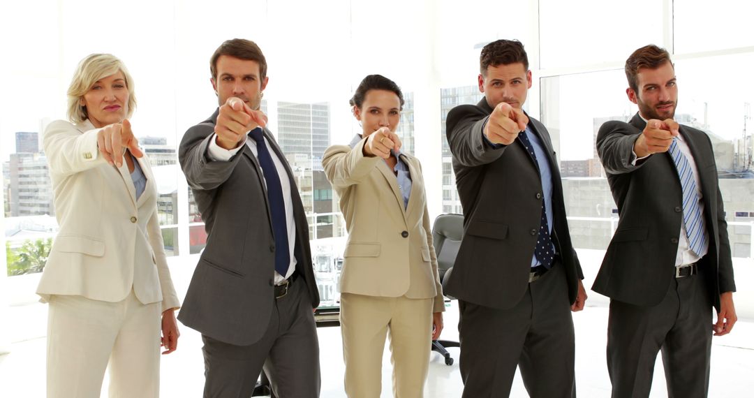 Confident Business Team Pointing in Modern Office