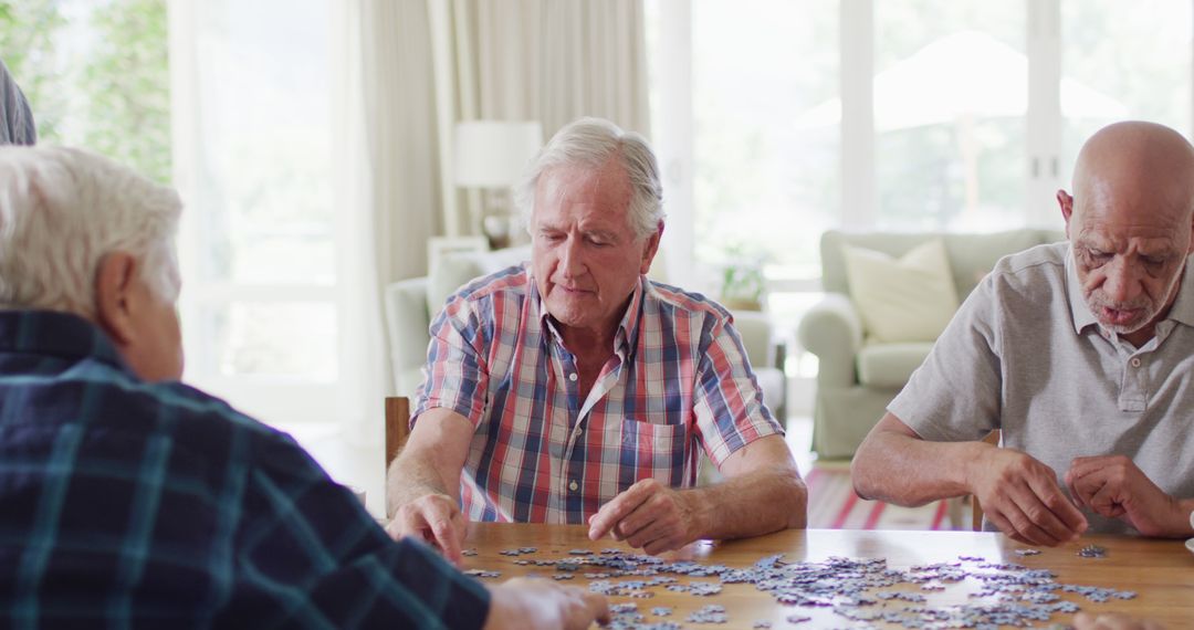 Senior Friends Assembling Jigsaw Puzzle Together at Home - Free Images, Stock Photos and Pictures on Pikwizard.com