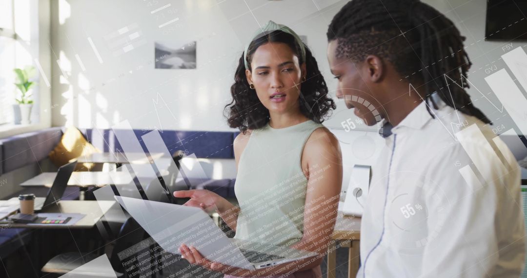 Colleagues Collaborating in Modern Office with Digital Graphics Overlay