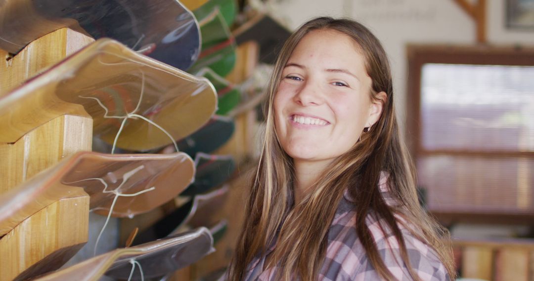 Smiling Young Woman in Skateboard Workshop - Free Images, Stock Photos and Pictures on Pikwizard.com