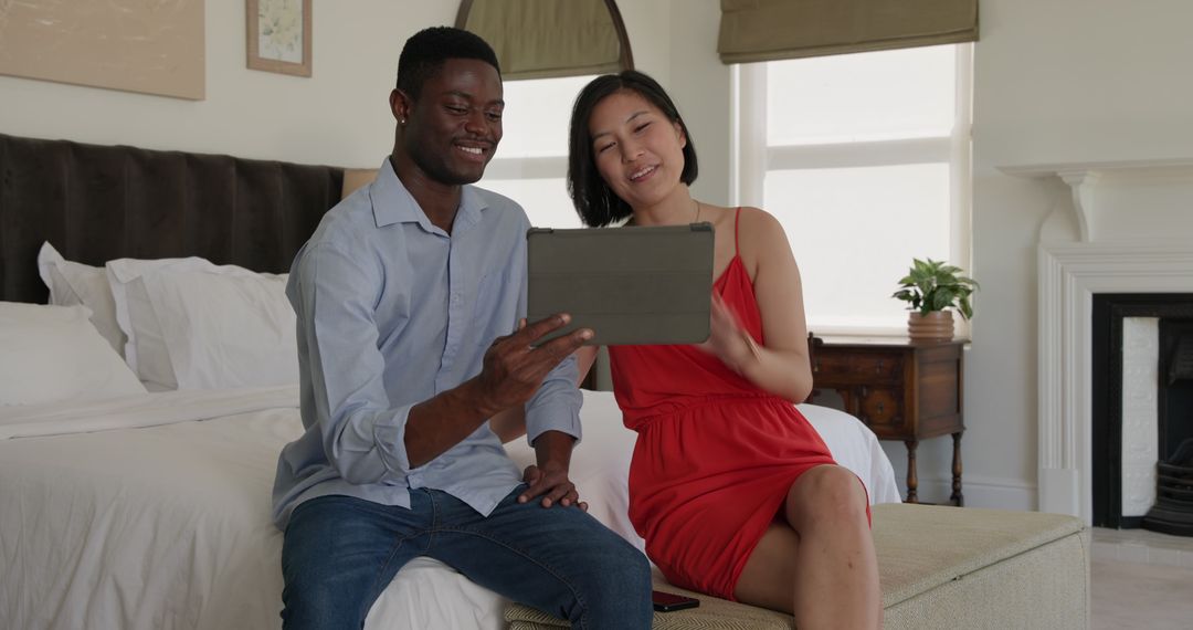 Diverse Couple Enjoying Tablet Technology at Home