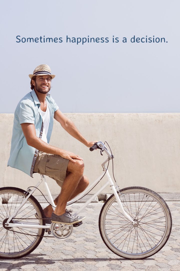 Joyful Young Man Riding Bicycle by Seaside in Summer Attire