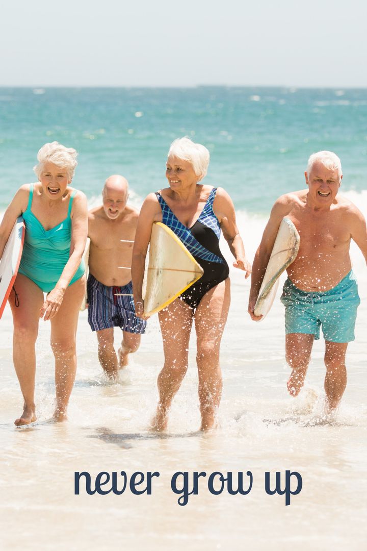 Joyful Seniors Running on Beach with Surfboards