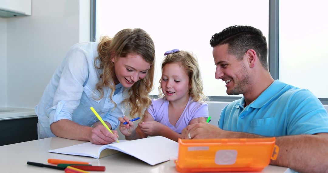 Happy Parents Helping Daughter with Homework at Home - Free Images, Stock Photos and Pictures on Pikwizard.com