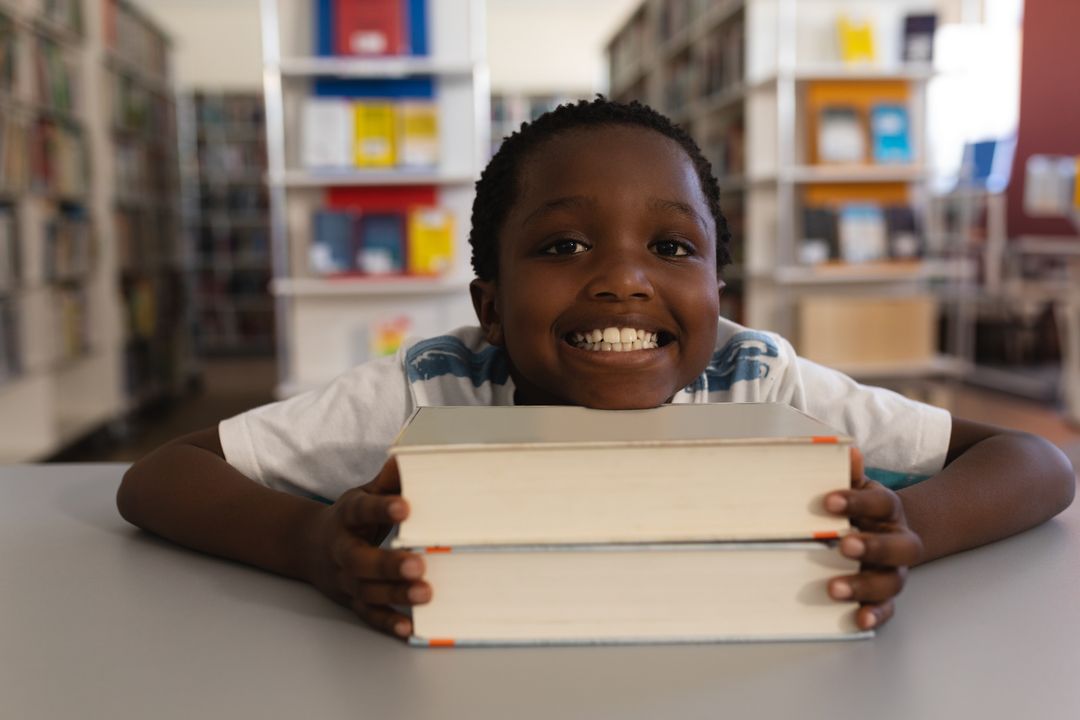Joyful Young Student in Library With Books