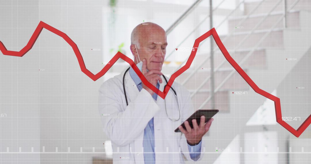 Senior Doctor Analyzing Data on Tablet with Declining Graph