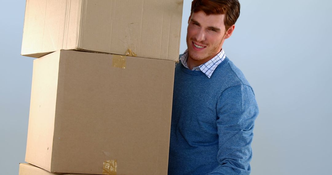 Man Carrying Stack of Cardboard Boxes with Effort - Free Images, Stock Photos and Pictures on Pikwizard.com