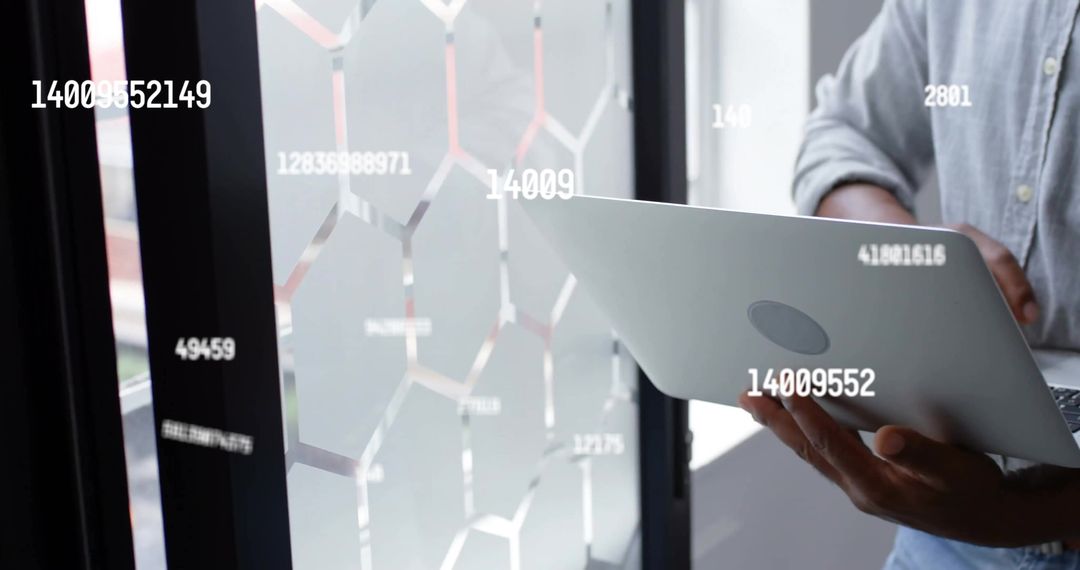 Businessman Using Laptop for Data Analysis in Modern Office