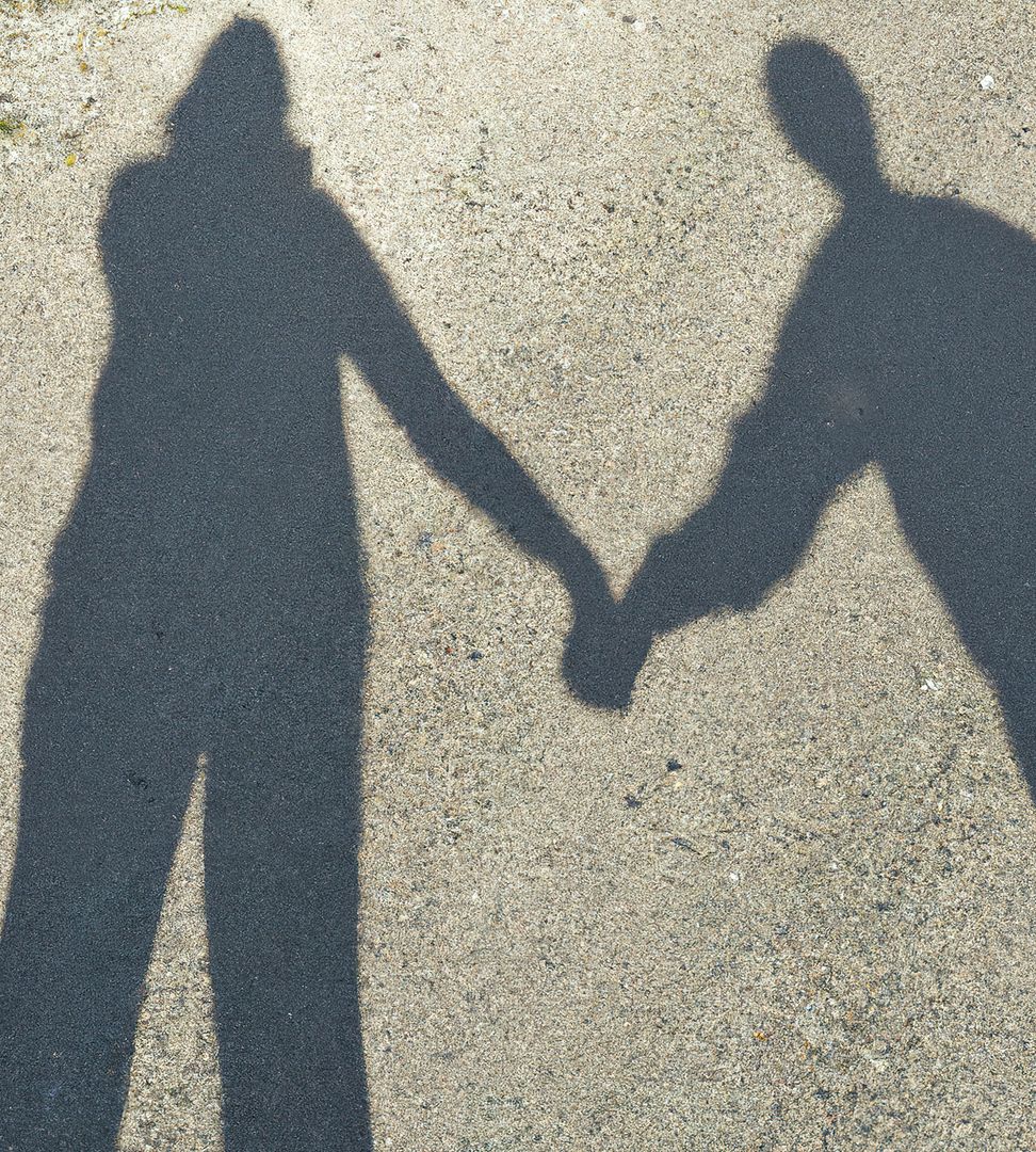 Silhouette Shadows of Couple Holding Hands on Pavement - Free Images, Stock Photos and Pictures on Pikwizard.com