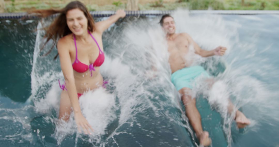 Couple Splashing in Pool on Sunny Day - Free Images, Stock Photos and Pictures on Pikwizard.com