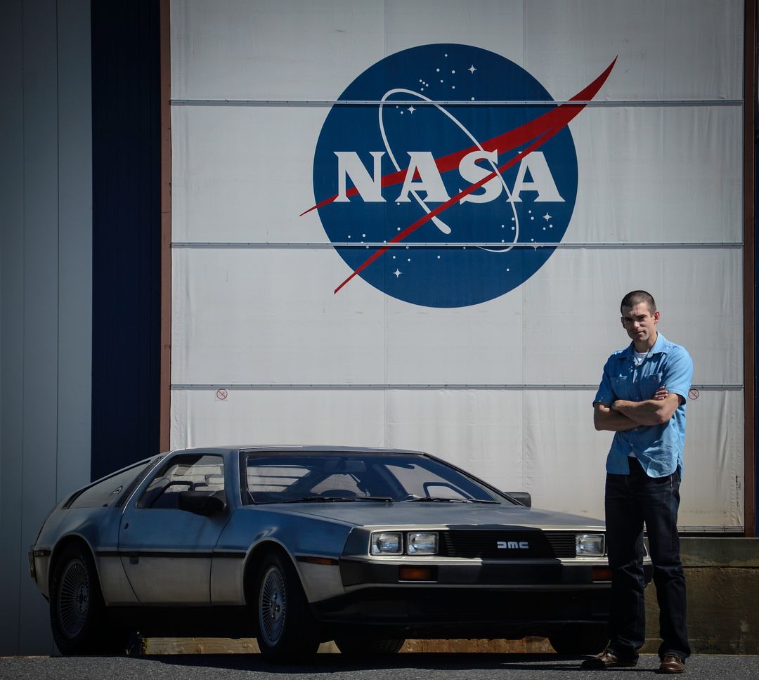 Man with DeLorean Car in Front of NASA Sign at Goddard Space Flight Center - Free Images, Stock Photos and Pictures on Pikwizard.com