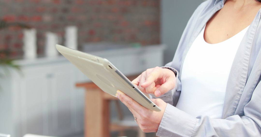 Person using digital tablet in modern home office - Free Images, Stock Photos and Pictures on Pikwizard.com