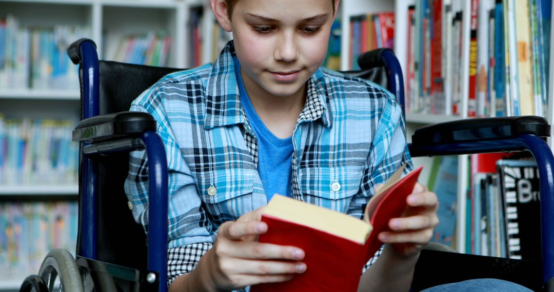 Young Boy in Wheelchair Reading Book in Library - Free Images, Stock Photos and Pictures on Pikwizard.com