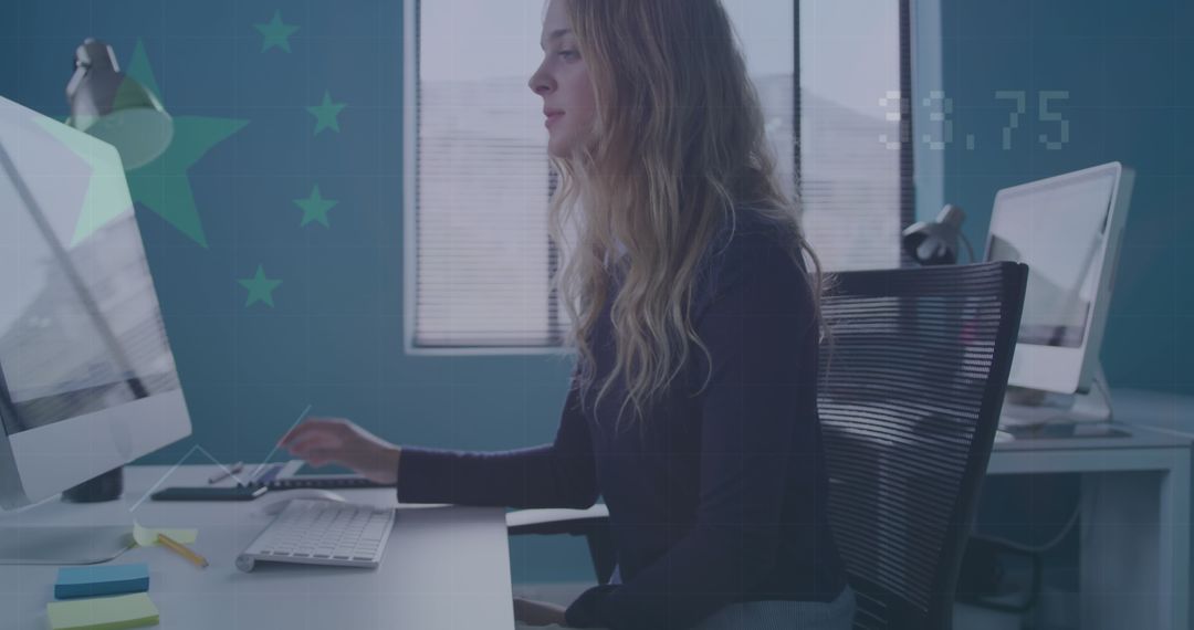 Focused Businesswoman Handling Financial Data on Computer