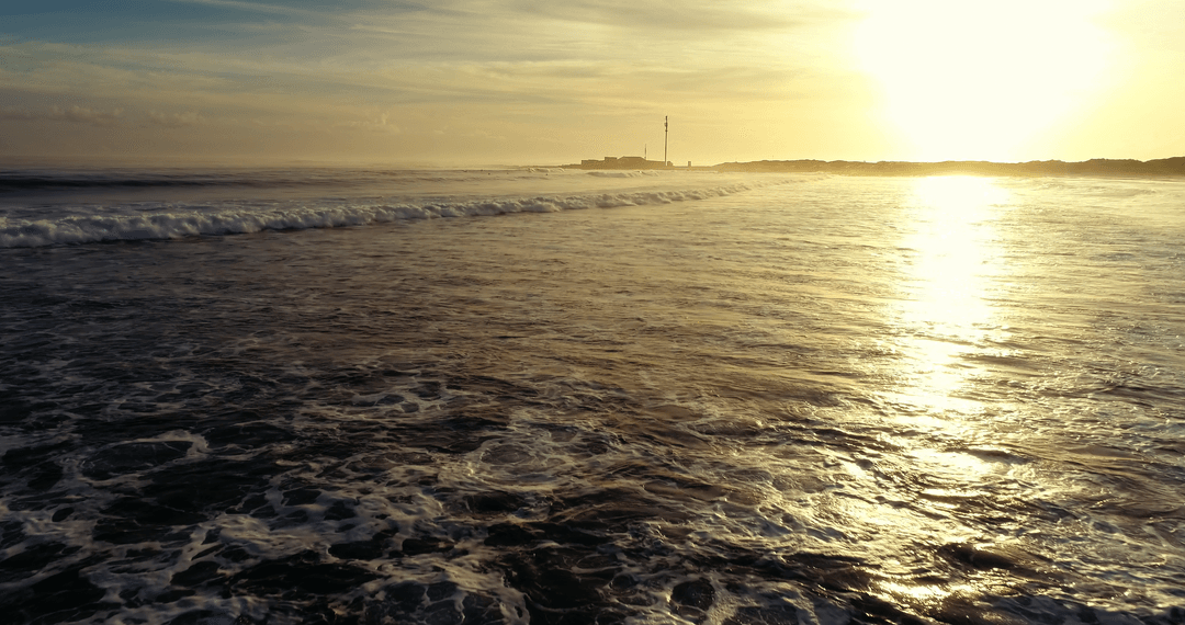 Breathtaking Transparent Ocean Waves at Sunset with Scenic Horizon