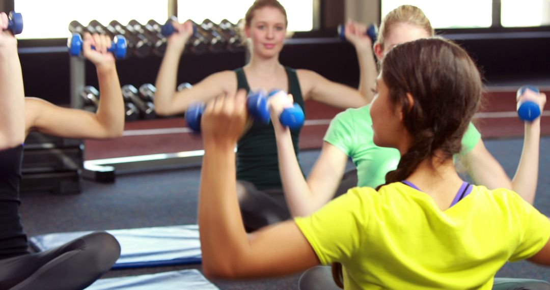 Diverse Women Lifting Dumbbells in Fitness Class - Free Images, Stock Photos and Pictures on Pikwizard.com