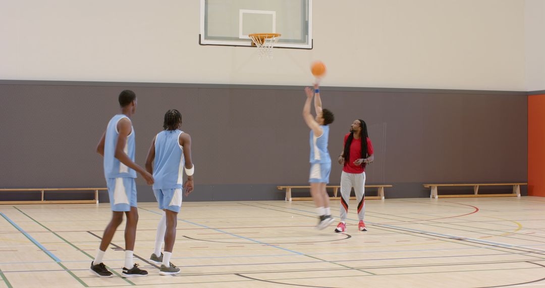 Diverse Basketball Team Practicing with Coach
