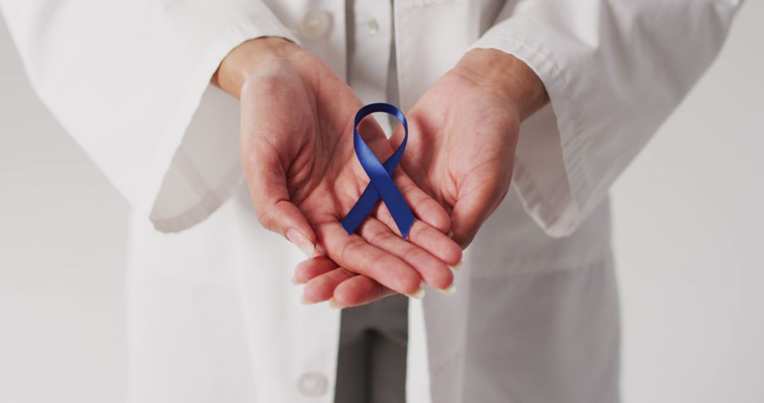 Image of biracial female doctor holding purple pancreatic cancer ribbon - Free Images, Stock Photos and Pictures on Pikwizard.com