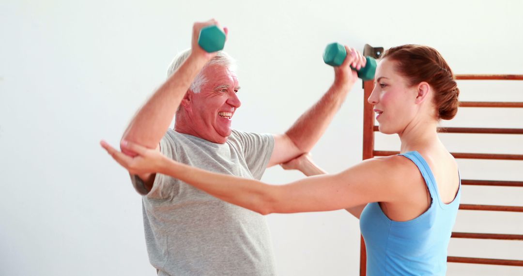 Senior Man Exercising with Personal Trainer Lifting Dumbbells - Free Images, Stock Photos and Pictures on Pikwizard.com