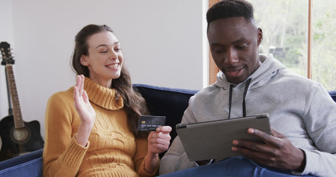 Happy Diverse Couple Online Shopping with Tablet and Credit Card