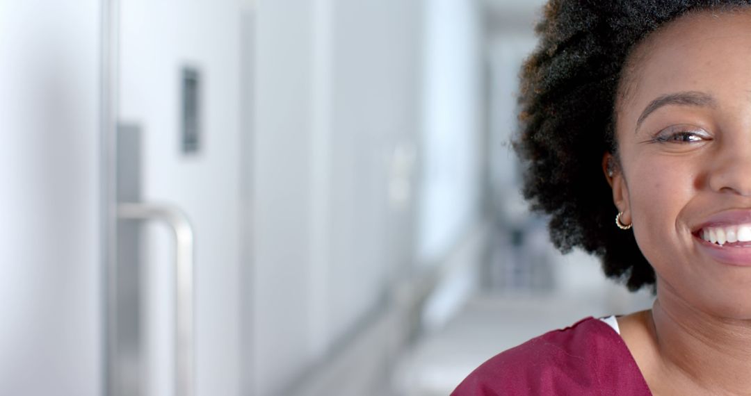 Female Healthcare Professional Smiling in Hospital Corridor - Free Images, Stock Photos and Pictures on Pikwizard.com