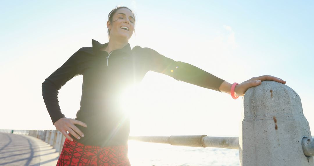 Female Runner Smiling After Morning Workout by Seaside - Free Images, Stock Photos and Pictures on Pikwizard.com