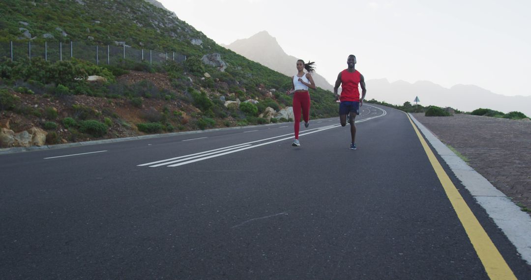 Couple Jogging on Scenic Mountain Road for Healthy Lifestyle - Free Images, Stock Photos and Pictures on Pikwizard.com