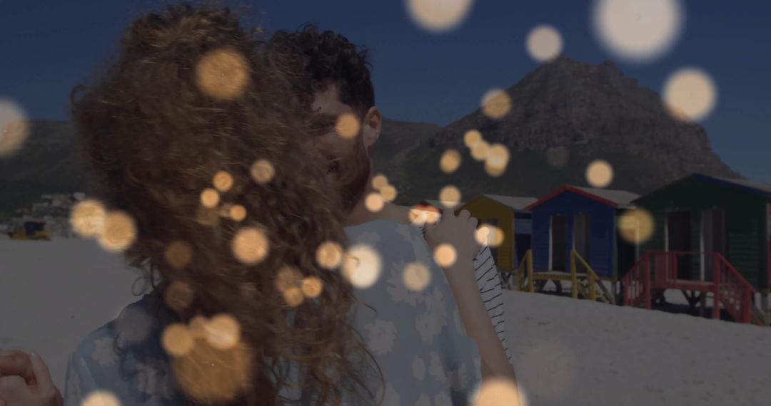 Romantic Embrace with Bokeh and Beach Cabins