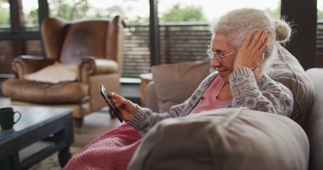 Elderly Woman Video Calling Friends or Family From Her Comfortable Living Room - Free Images, Stock Photos and Pictures on Pikwizard.com