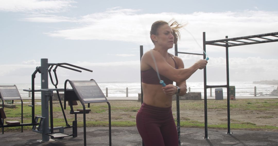 Fit Woman Jump Roping in Outdoor Gym by the Beach - Free Images, Stock Photos and Pictures on Pikwizard.com