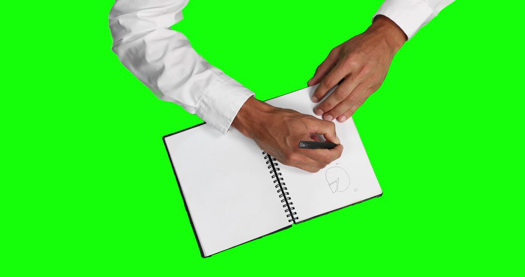 Man drawing on blank notebook with green screen background - Free Images, Stock Photos and Pictures on Pikwizard.com