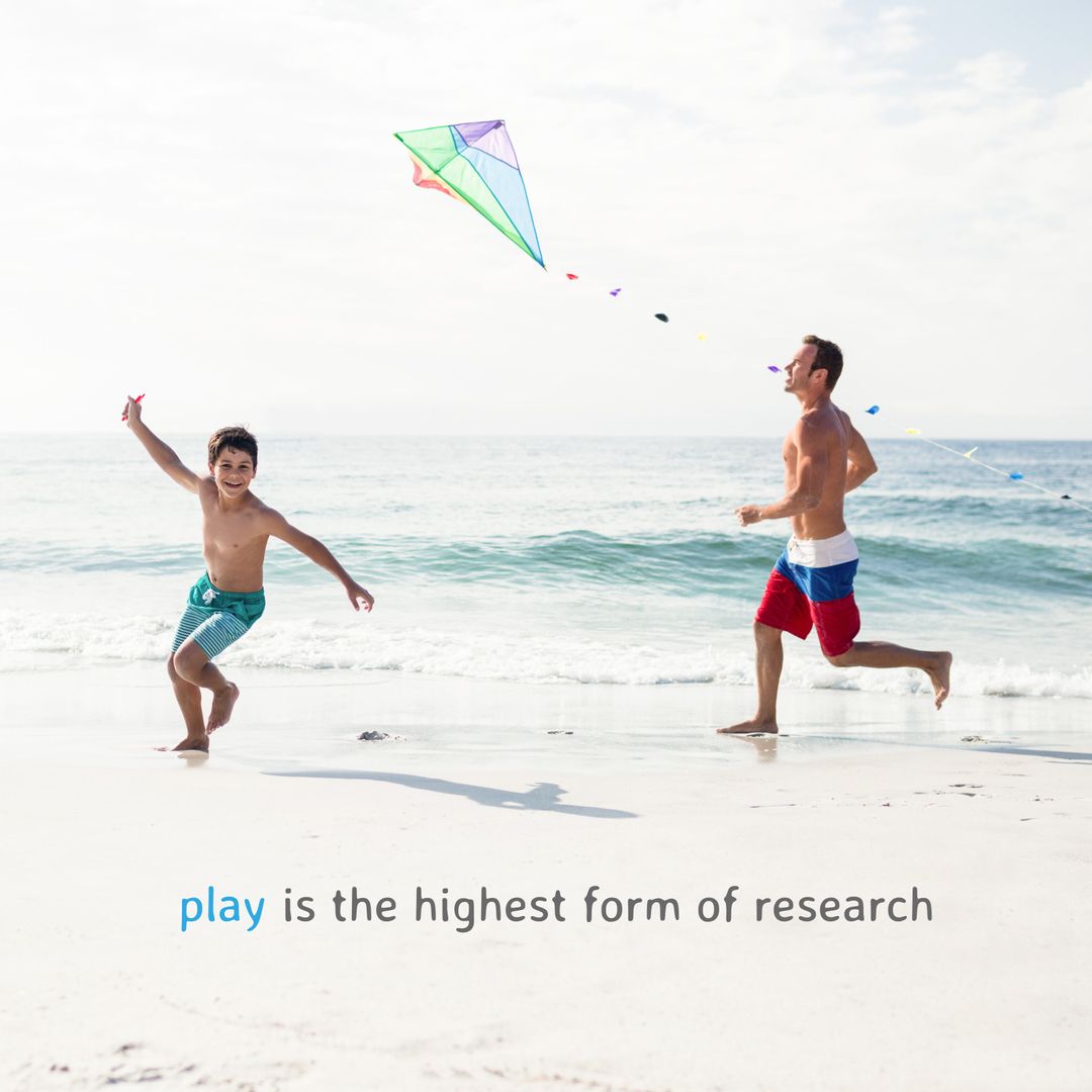 Father and Son Enjoying Kite Flying on Sunny Beach