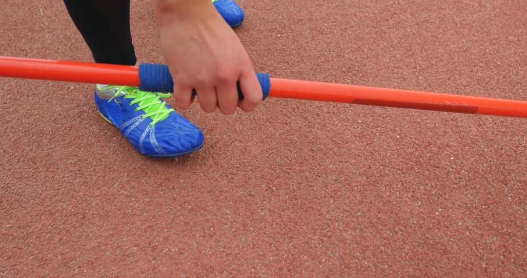 Athlete Preparing for Javelin Throw on Track
