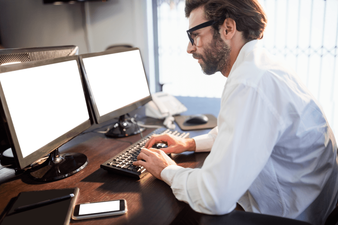 Professional Man with Glasses Working at Office Desk with Transparent Monitors