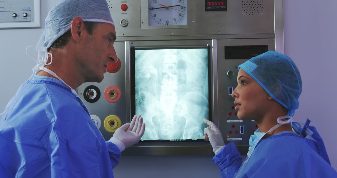 Surgeons Reviewing X-Ray in Operating Room - Free Images, Stock Photos and Pictures on Pikwizard.com